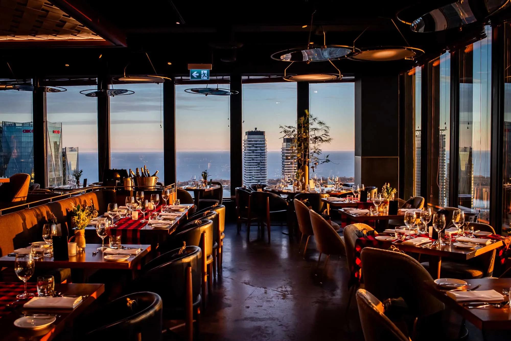 Dining room from Canoe with a view out the window int the Toronto skyline.